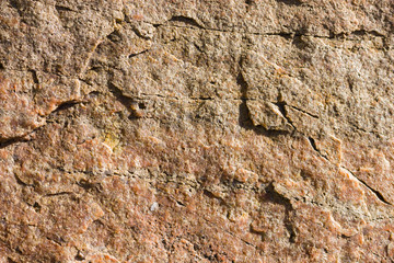 Background of granite. Texture of granite stone. Pattern of roughened surface. Texture of brown stone