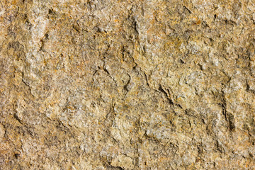 Background of granite. Texture of granite stone. Pattern of roughened surface. Texture of brown stone
