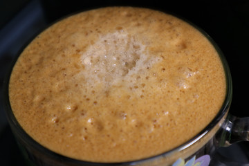 thick foam of fragrant fresh coffee brewed in the coffee maker
