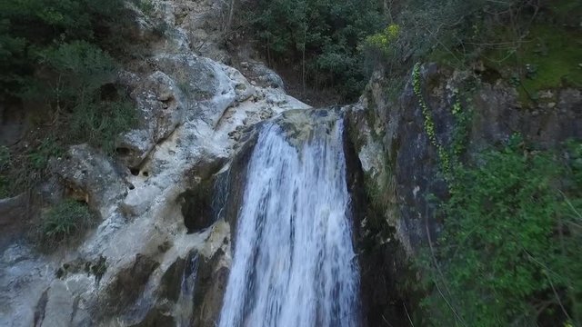 Drone shot of a waterfall feeding a stream at Lassa, Mount Lebanon