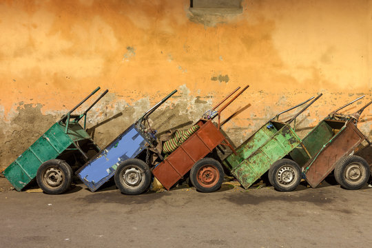 Row of carts against weathered wall