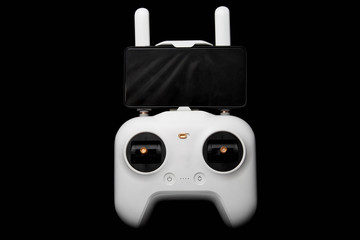 White wireless control panel for the drone and mobile phone for the first person view. FPV system. Joystick for copter. Isolated on a black background. © Dmitry Dven
