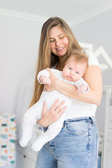 Mom and newborn baby in her arms. The concept of new life, love and helplessness. Lips bow