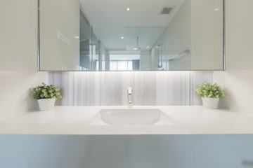 Fototapeta na wymiar Condo bathroom design with single vanity cabinet and grey tiles on the walls.