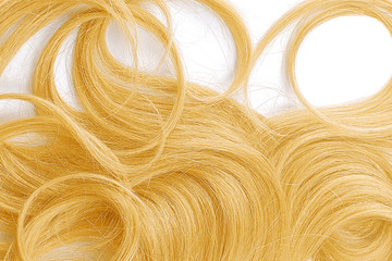 Curly blond hair as background, texture. One of the popular shades of hair coloring..