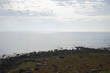beautiful mountain landscape, stones, green grass, blue sea,
