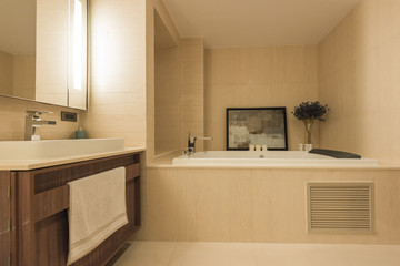 Condo bathroom design with single vanity cabinet and grey tiles on the walls.