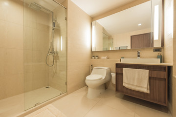 Fototapeta na wymiar Condo bathroom design with single vanity cabinet and grey tiles on the walls.