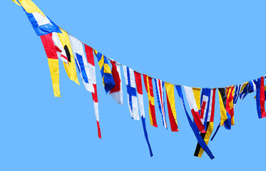 Garland of flags. Multicolored flags isolated on blue sky background