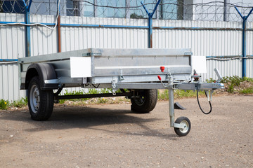 Open car trailer. Trailer store. Assembly of car trailers.