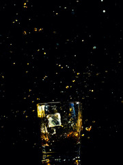 Isolated shot of whiskey with splash on black background