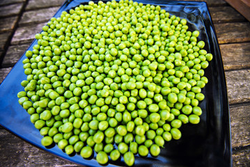 Green peas on wooden background