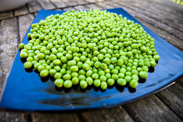 Green peas on wooden background