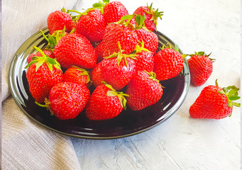 fresh strawberry plate on gray concrete background