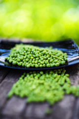 Green peas on wooden background
