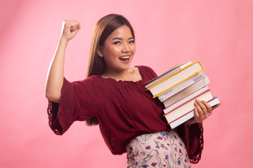 Young Asian woman studying  with may books.