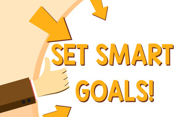 Writing note showing Set Smart Goals. Business concept for list to clarify your ideas focus efforts use time wisely Hand Gesturing Thumbs Up and Holding Round Shape with Arrows