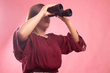 Young Asian woman with binoculars.