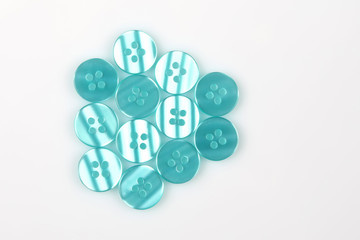 different mother of pearl buttons on a white background