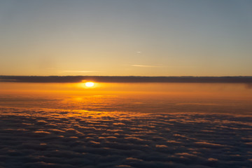 Flying over the evening timelapse clouds with the late sun. Flight through moving cloudscape with beautiful sun rays
