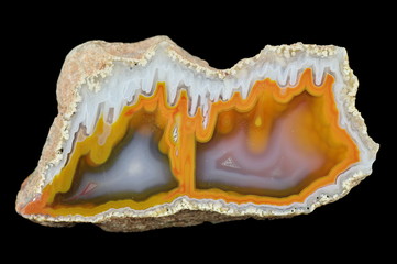 Fototapeta premium A cross section of the stalactite agate. Multicolored silica bands colored with metal oxides are visible.