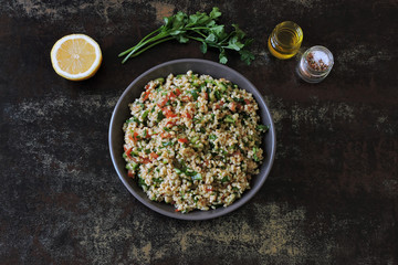 Salad with bulgur, vegetables and parsley. Lemon salad with bulgur. Vegan food.