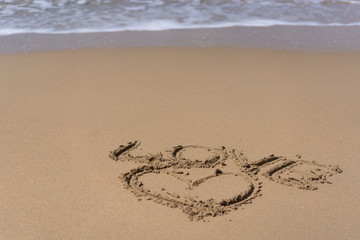 Heart and word love drawn on beach sand