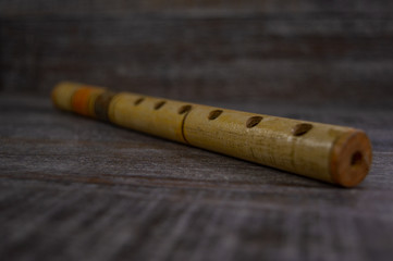 Wooden musical instrument recorder isolated on a dark grey background. © Josif