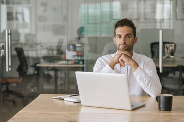 Focused young businessman working at his office desk