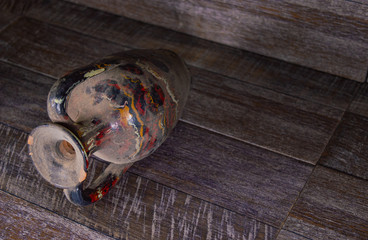 Old ceramic vintage teapot isolated on a wooden background.
