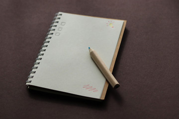 school notebook on a brown background, a spiral notebook on the table