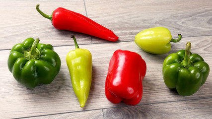 group of colorful sweet peppers on a wooden table