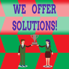 Writing note showing We Offer Solutions. Business concept for way to solve problem or deal with difficult situation Man and Woman Business Suit Holding Championship Trophy Cup