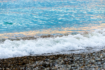Seashore on stone beach. Close up view.