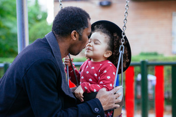 Obraz premium lovely little girl bonding with dad. Sweet latin kid playing nose games with her parent