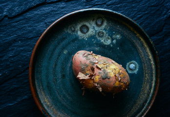 Raw new organic potatoes in a plate top view space for text 
