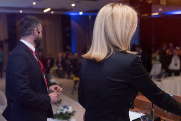 Young businessman and business woman at business conference room with public giving presentations. Audience at the conference hall. Entrepreneurship club.