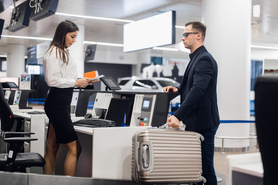 Handsome Businessman Handing Over Air Ticket At Airline Check In Counter