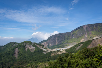 Fototapeta premium A scenic view of mountain Papandayan with clear blue sky. The view of Tebing Soni and Papandayan Crater. Papandayan Mountain is one of the favorite place to hike on Garut.