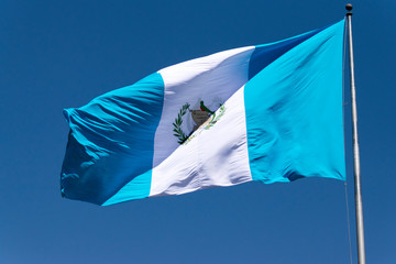 National flag of Guatemala, Central America, to the wind in antler, patriotic symbol, September 12, 1968 current version. Guatemala flag, national symbol, waving on the wind