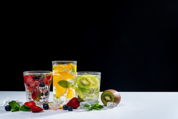 detox smoothies of fresh fruits and vegetables on dark background