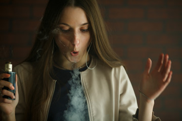 Vaping teenager. Young pretty white girl smoking an electronic cigarette in vape bar. Bad habit.