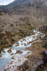 Obraz premium Rocky stream with white water on a mountain. Beautiful landscape of mount Papandayan. Papandayan Mountain is one of the favorite place to hike on Garut.