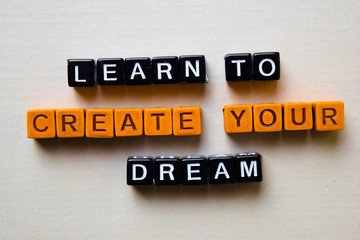Learn to Create Your Dream on wooden blocks. Business and inspiration concept
