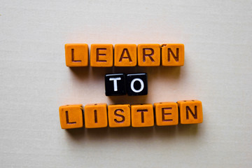 Learn to Listen on wooden blocks. Business and inspiration concept