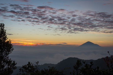 Warm morning sunrise on Ghober Hut campsite with view of mount Cikuray. Beautiful landscape of mount Papandayan. Papandayan Mountain is one of the favorite place to hike on Garut.