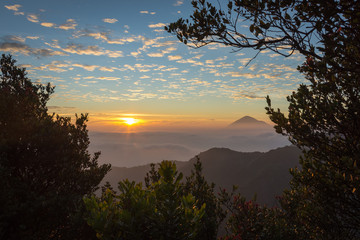 Warm morning sunrise on Ghober Hut campsite with view of mount Cikuray. Beautiful landscape of mount Papandayan. Papandayan Mountain is one of the favorite place to hike on Garut.