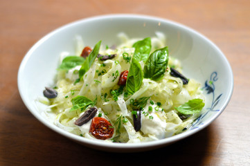 Delicious gourmet green fresh fennel salad with sun dried tomatoes and olives