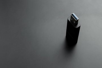 usb memory stick at black matte background. portable storage device.