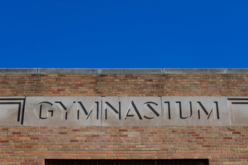 Old Gymnasium Sign on a School Building